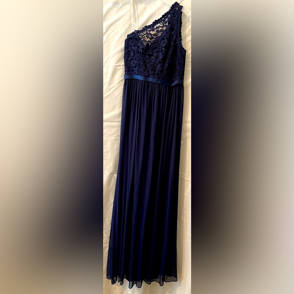 It is lace at the top and chiffon on the bottom. One shoulder with a zipper.